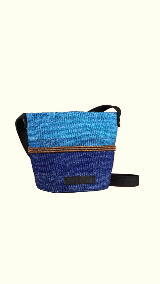 light blue and blue basket bag with a lather straps.
