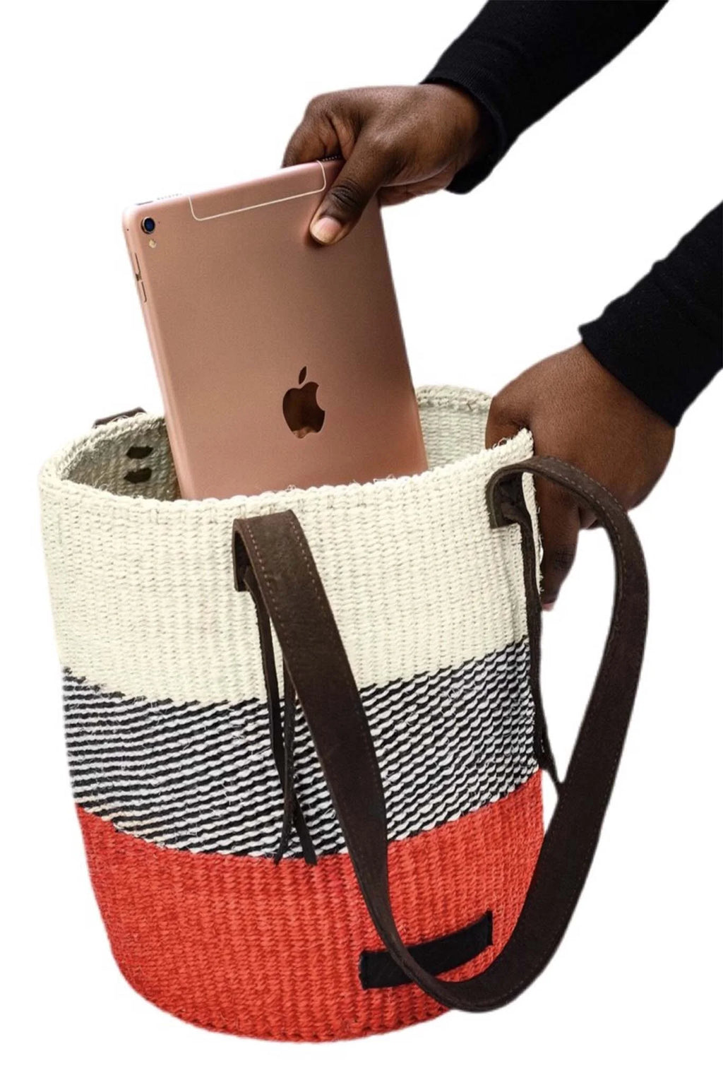 Woven bag with a striped pattern held by a person with an Apple device inside.