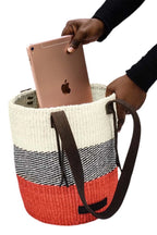 Woven bag with a striped pattern held by a person with an Apple device inside.