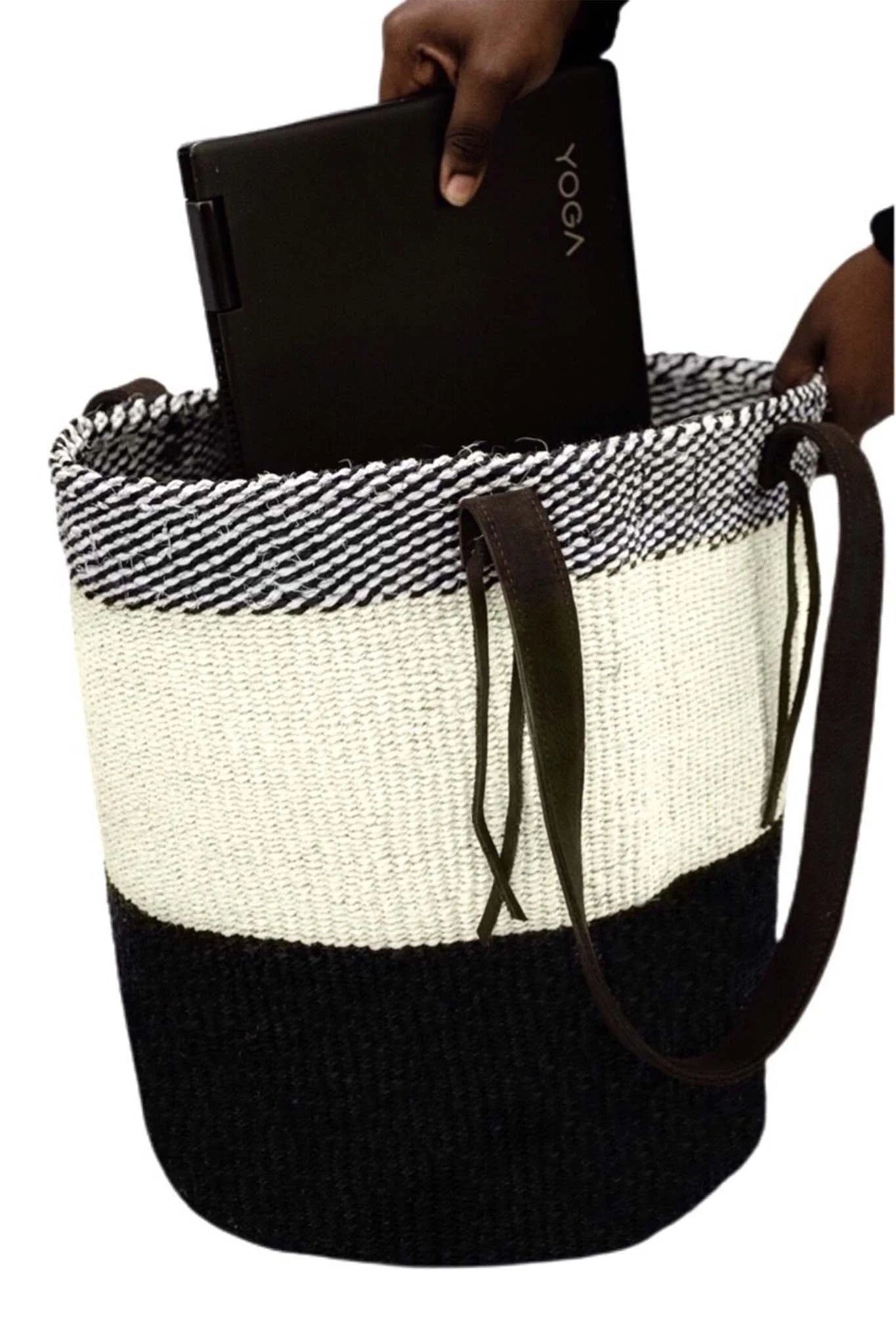 Black and white woven basket with a brown drawstring holding a black device.