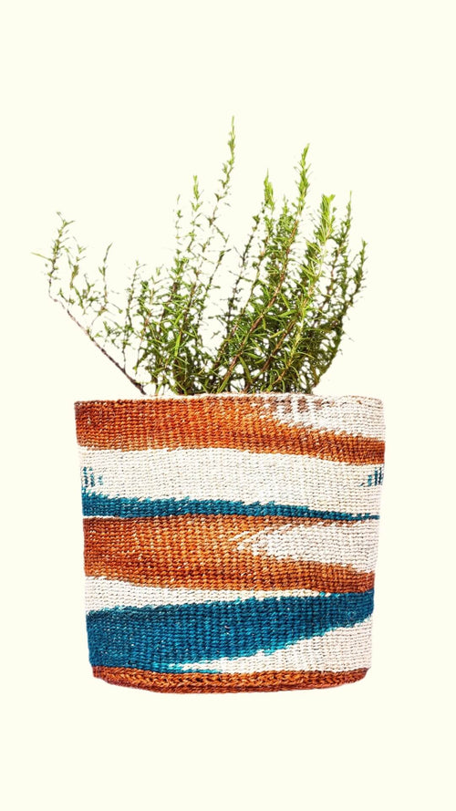 Woven plant pot with striped pattern on a white background