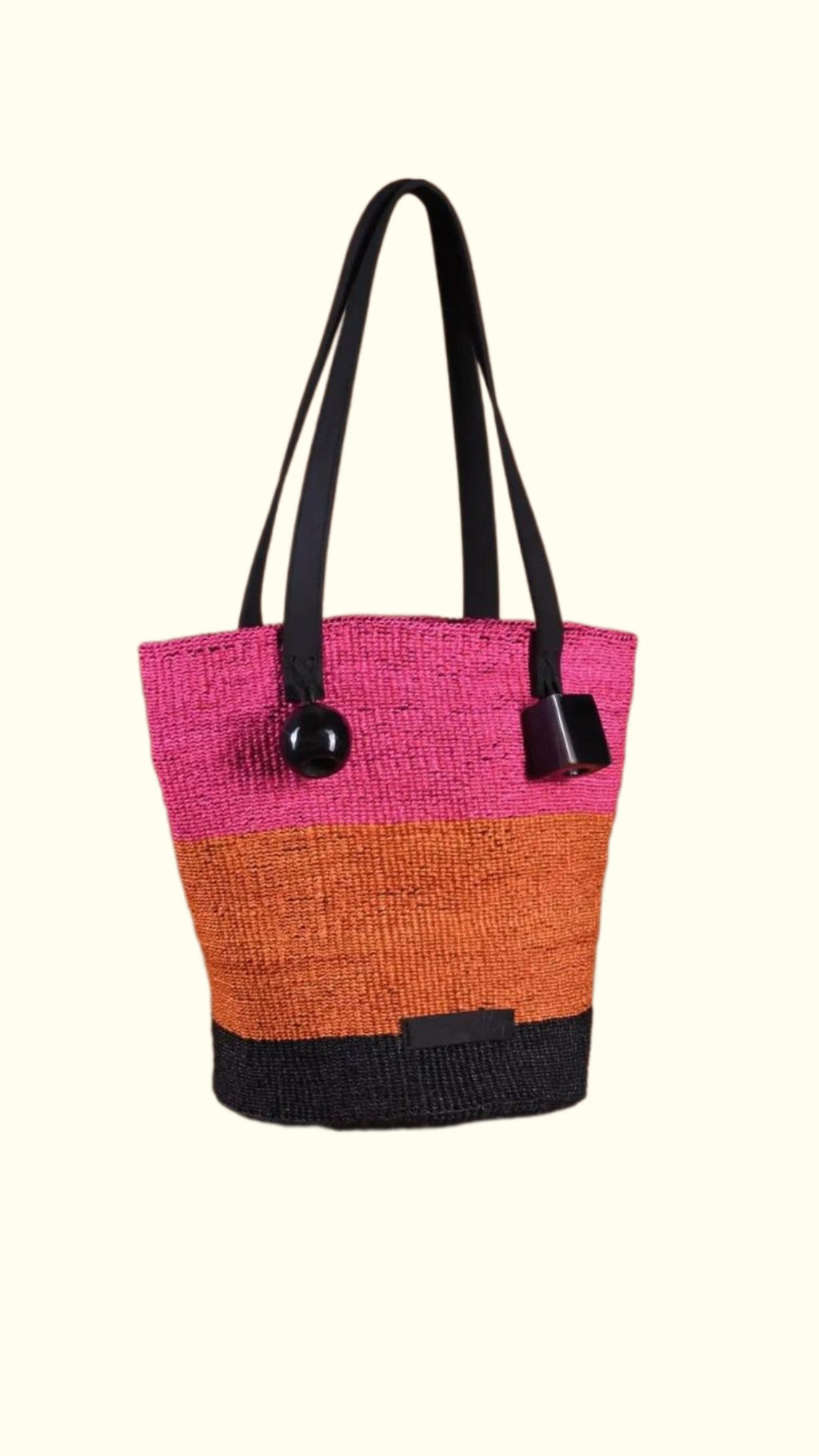 Multicolored tote bag with black handles on a white background