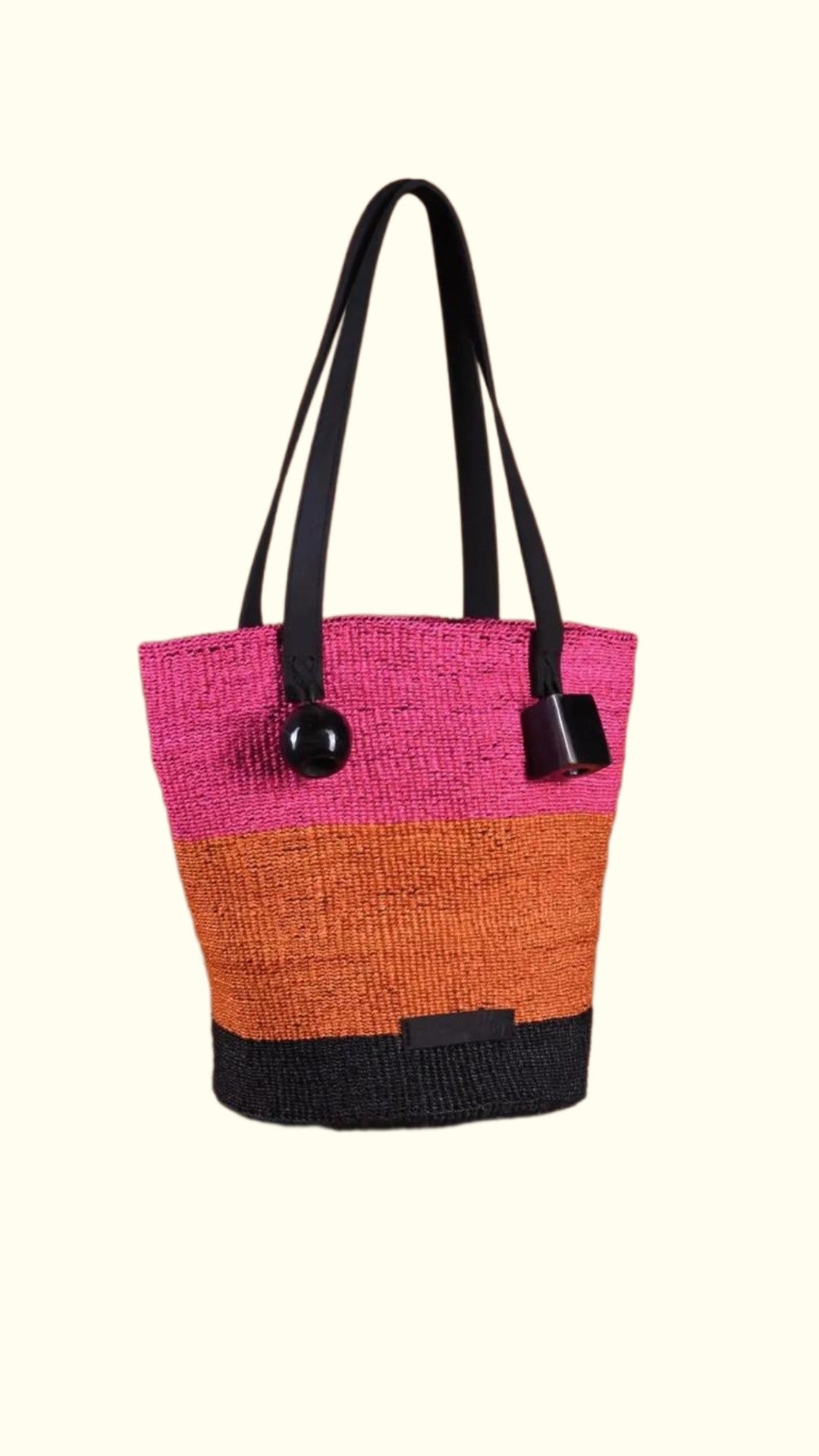 Multicolored tote bag with black handles on a white background