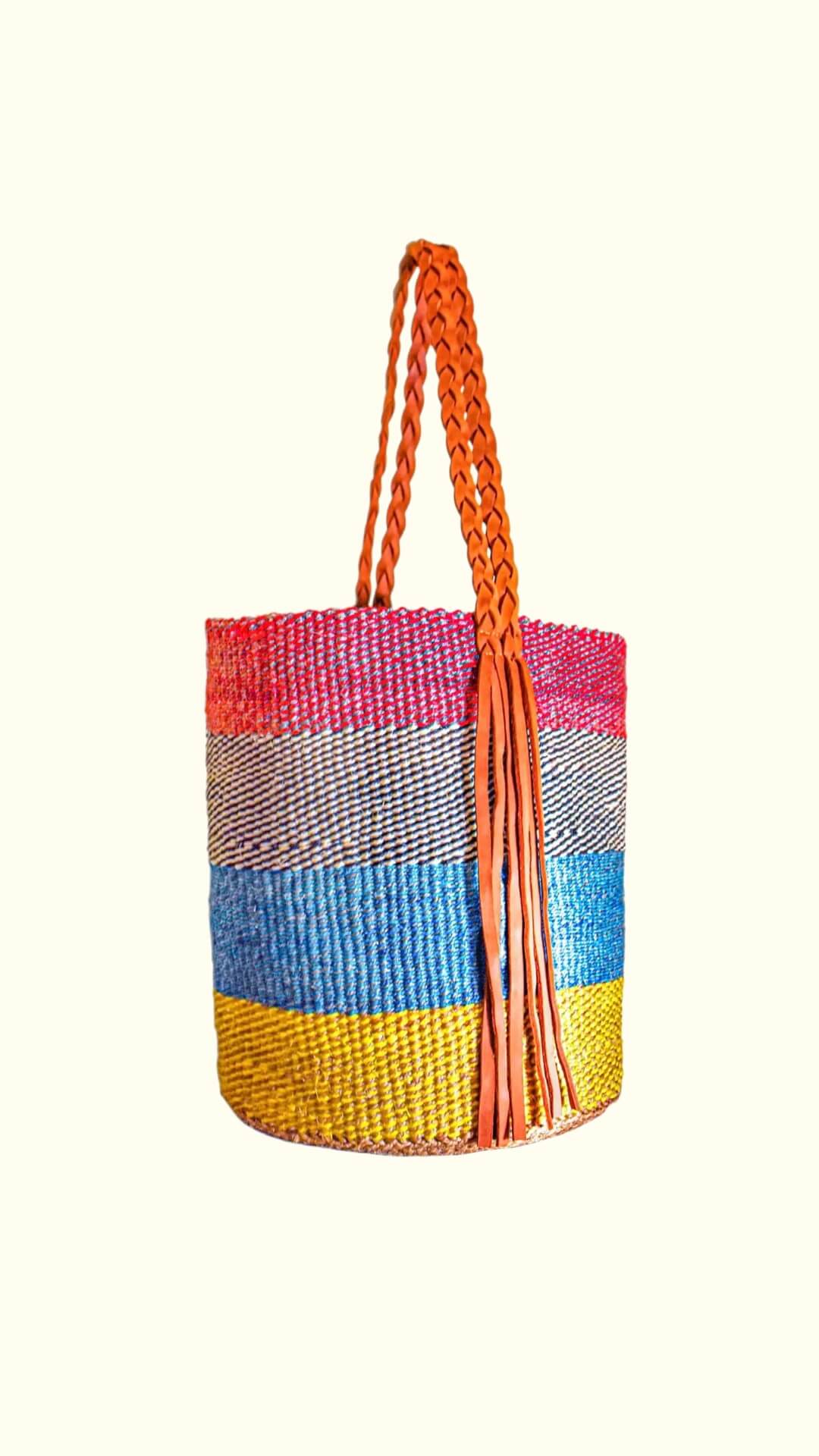 Colorful woven bag with a tassel on a white background