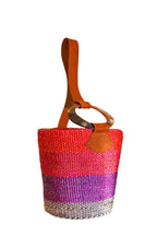 Colorful woven bag with a brown handle on a white background