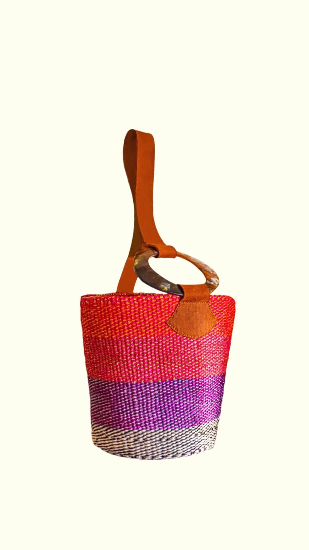 Multicolored woven artisan bag with a brown handle on a white background