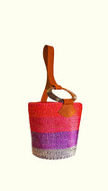 Multicolored woven artisan bag with a brown handle on a white background