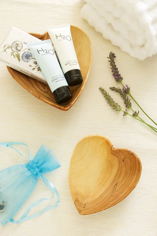 Wooden heart-shaped dish with skincare products and lavender on a light background, artisan-made on afrogaze.com